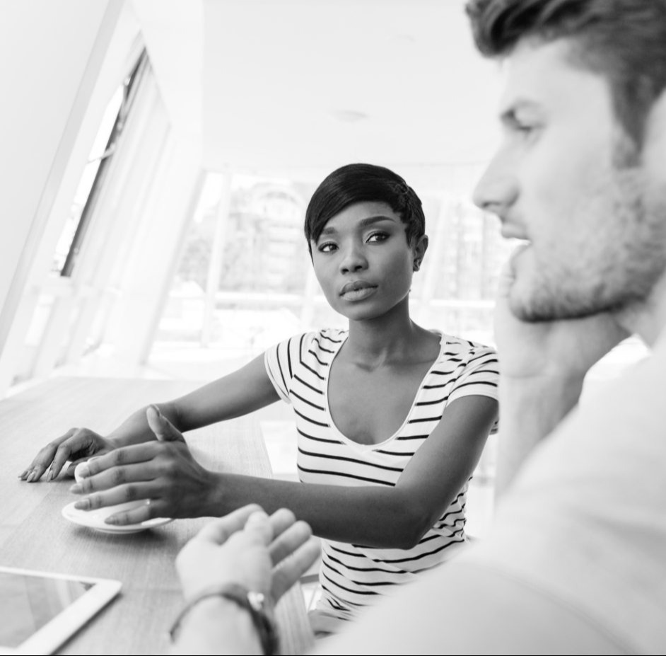 Businesswoman-and-smiling-businessman-discussing-work-in-restaurant@2x-modified